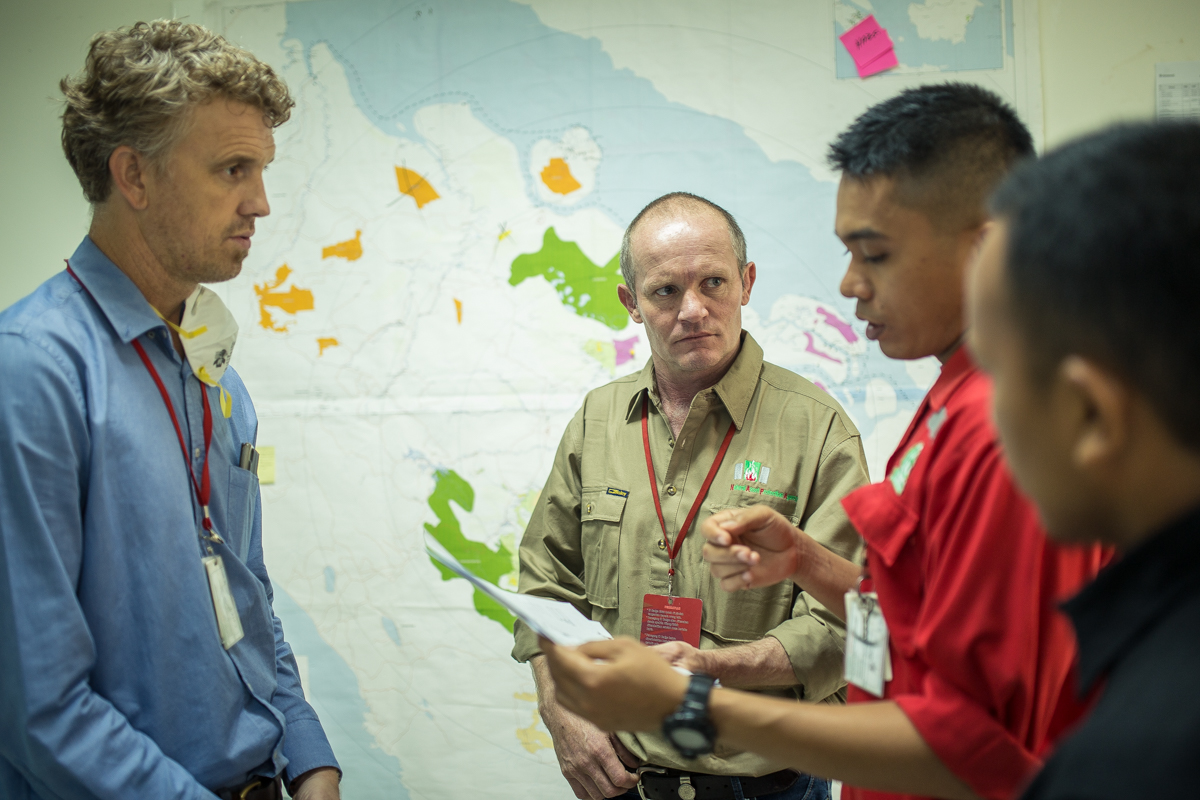 Robert Webb (center), at the Fire Control Center during fire threats briefing 